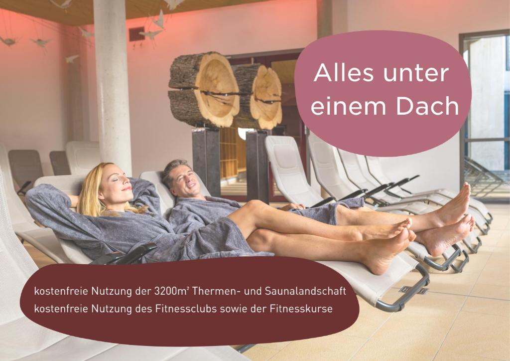 a man and a woman laying in beds in a waiting room at feelMOOR - Gesundresort Bad Wurzach in Bad Wurzach