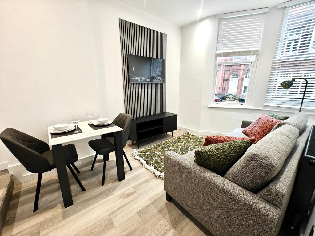 a living room with a couch and a table at Executive 1-Bed Apartment in Town in Bury