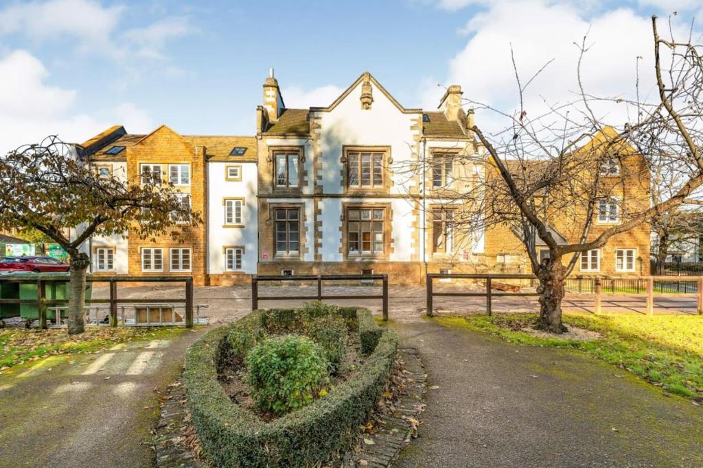 a large house with a garden in front of it at Flat 12- The Meadow in Banbury