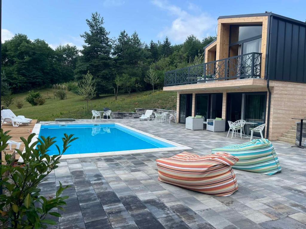a villa with a swimming pool and a house at Šumska Duša in Banja Luka