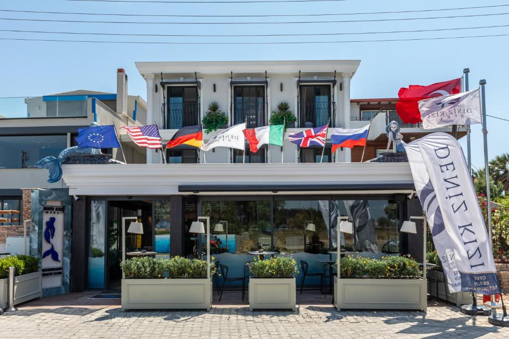 a building with flags in front of it at Deniz Kızı Urla Otel in Urla