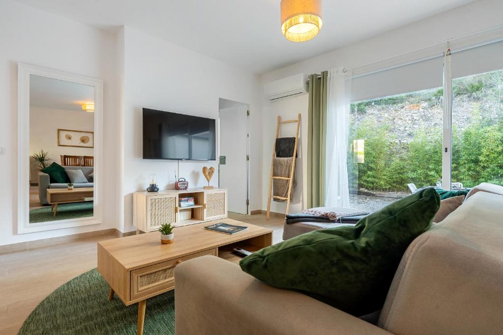 a living room with a couch and a table at Hauzify I Casa Olivella A in Olivella