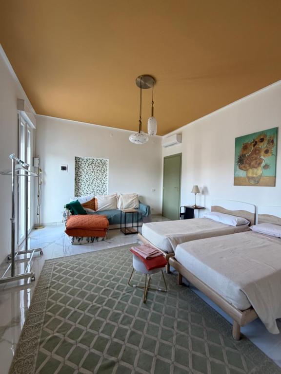 a large bedroom with two beds and a couch at Apartment Rino 1 Caorso in Caorso