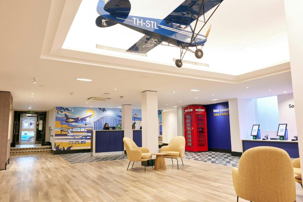 a plane hanging from the ceiling in a waiting room at Thistle London Heathrow Terminal 5 in Hillingdon