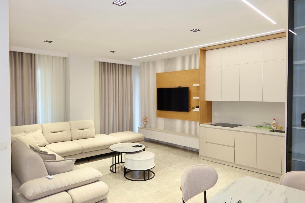 a living room with a couch and a table at Ilyonis Residence apartment luxury in Shëngjin