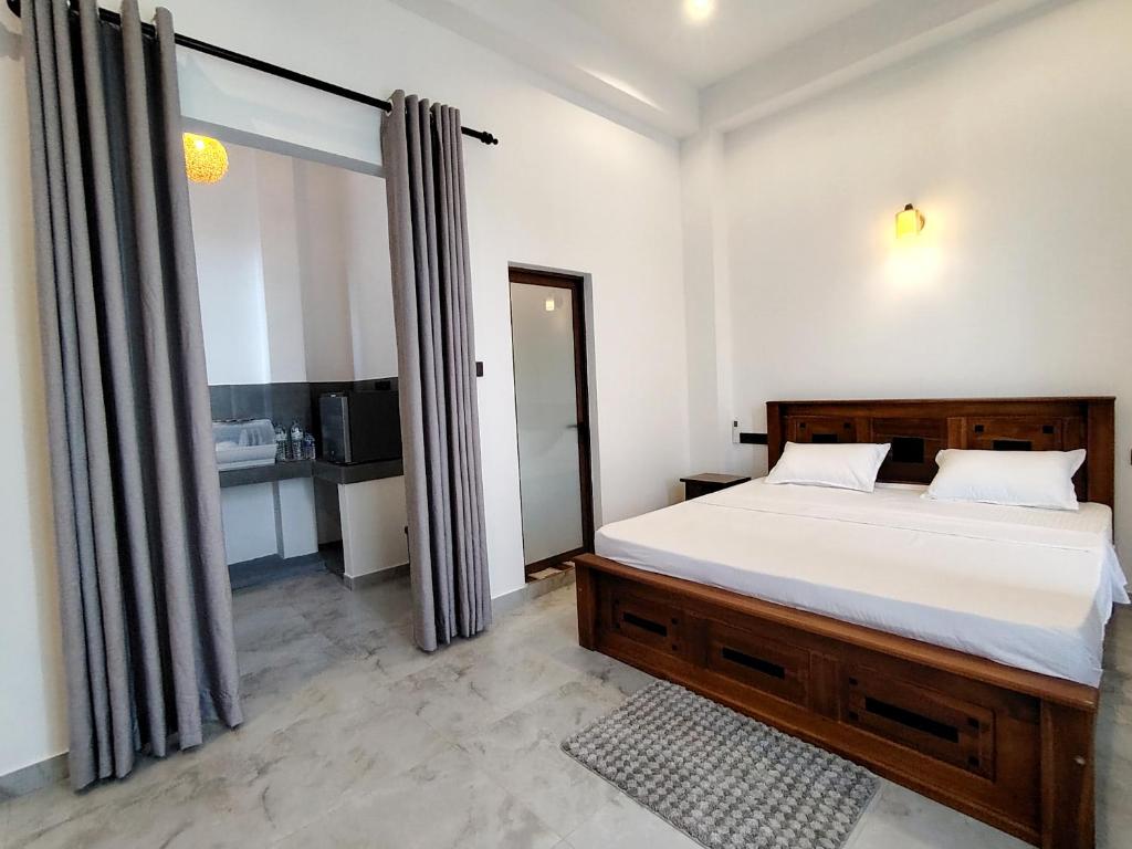 a bedroom with a large bed and a bathroom at Calvian Villa in Walliwala East