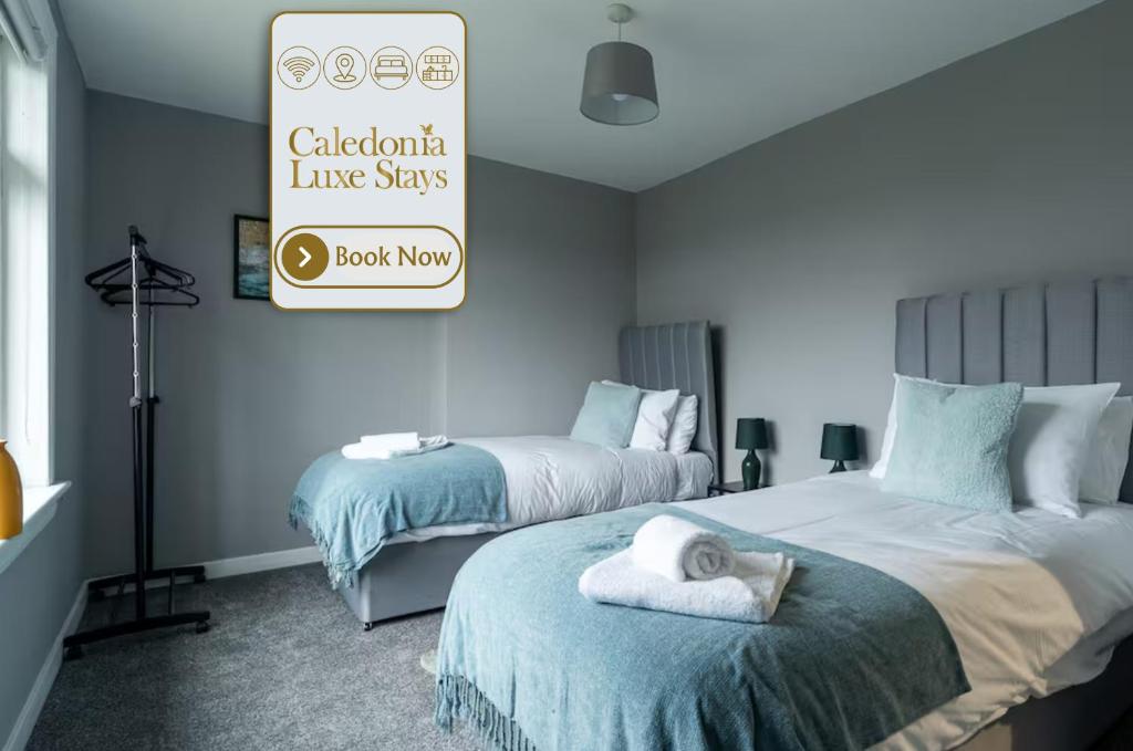 a bedroom with two beds and a sign that reads cattoria line stars at The Bowhouse in Grangemouth