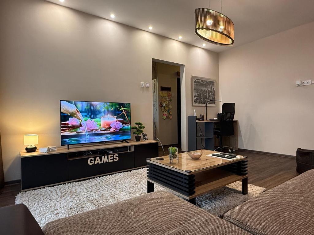 a living room with a large flat screen tv at City Edge Hideaway Apartment in Nagykanizsa