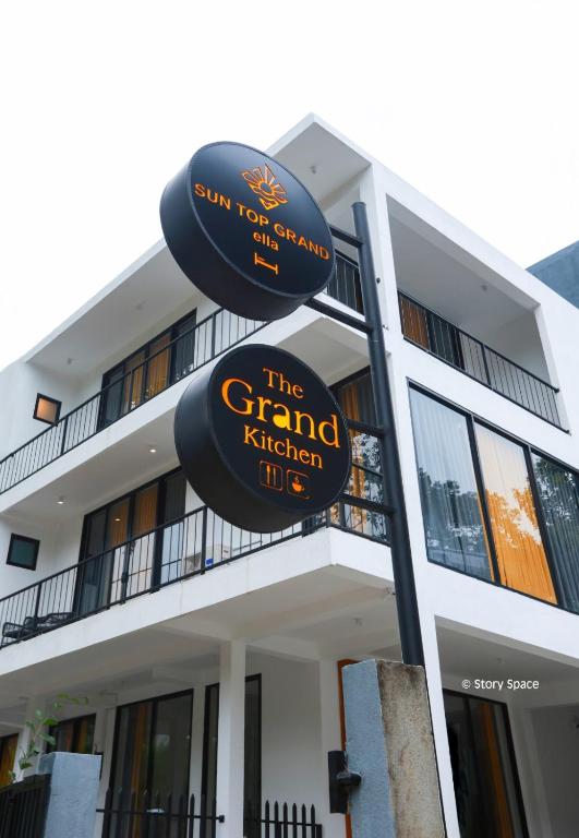 a building with a sign for the grand kitchen life at Sun Top Grand in Ella