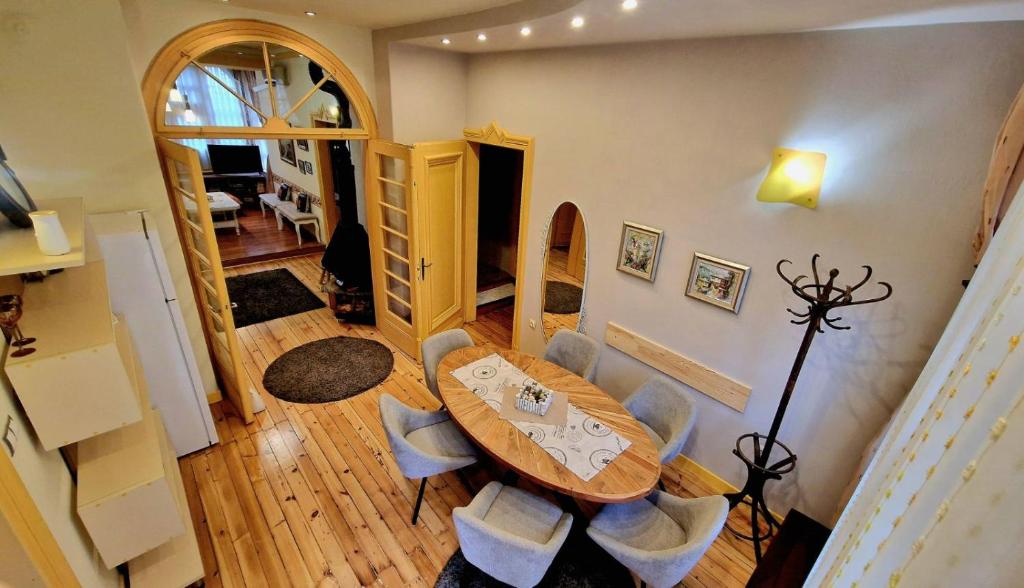 a dining room with a table and some chairs at TOMOVI HOME - Three bedrooms City center in Plovdiv