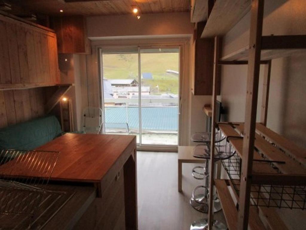 a room with a kitchen with a large window at Studette cosy 2 pers centre station La Mongie - FR-1-404-120 in La Mongie