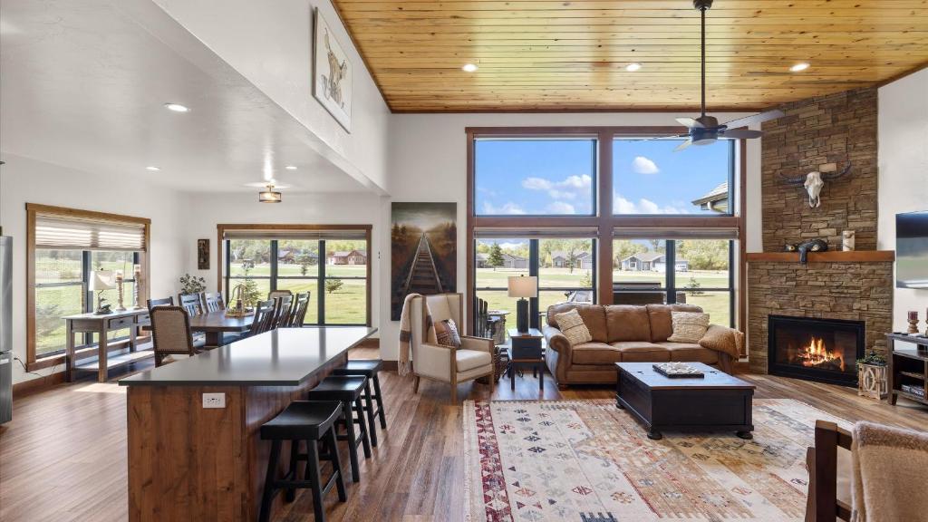 a living room with a table and a fireplace at Paradise View in Red Lodge