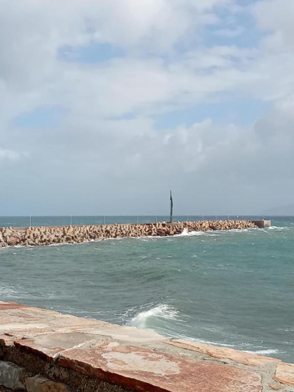 a body of water with a pier in the background at Mary Mary! in Agios Kirykos