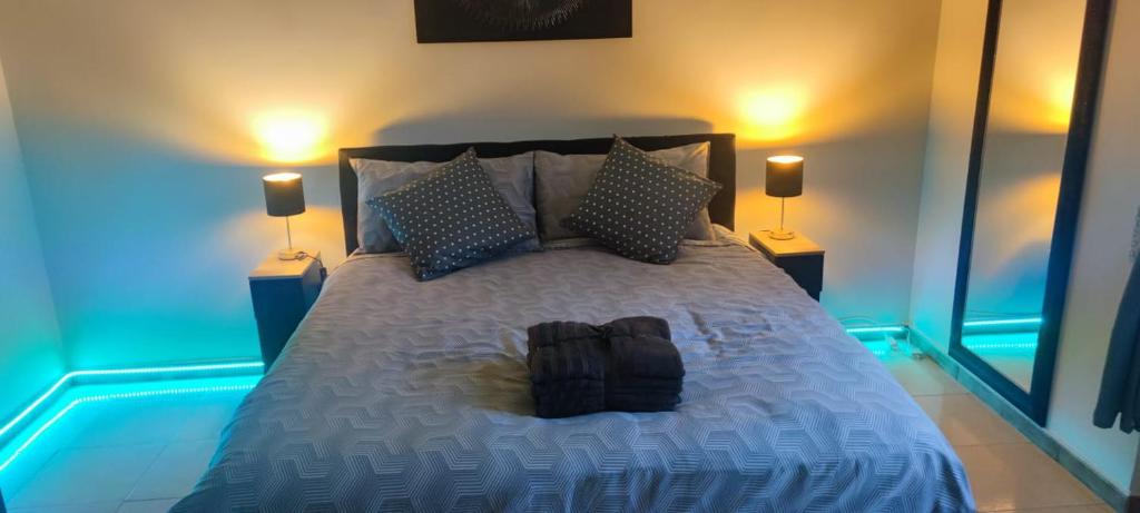 a bedroom with a large bed with two lamps at The Reggia Nest in Caserta
