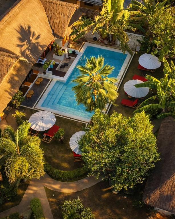 an overhead view of a swimming pool with umbrellas and chairs at Villa Kasadya in Panglao Island