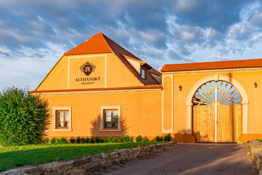 an orange building with a sign on the side of it at Althanský penzion in Znojmo