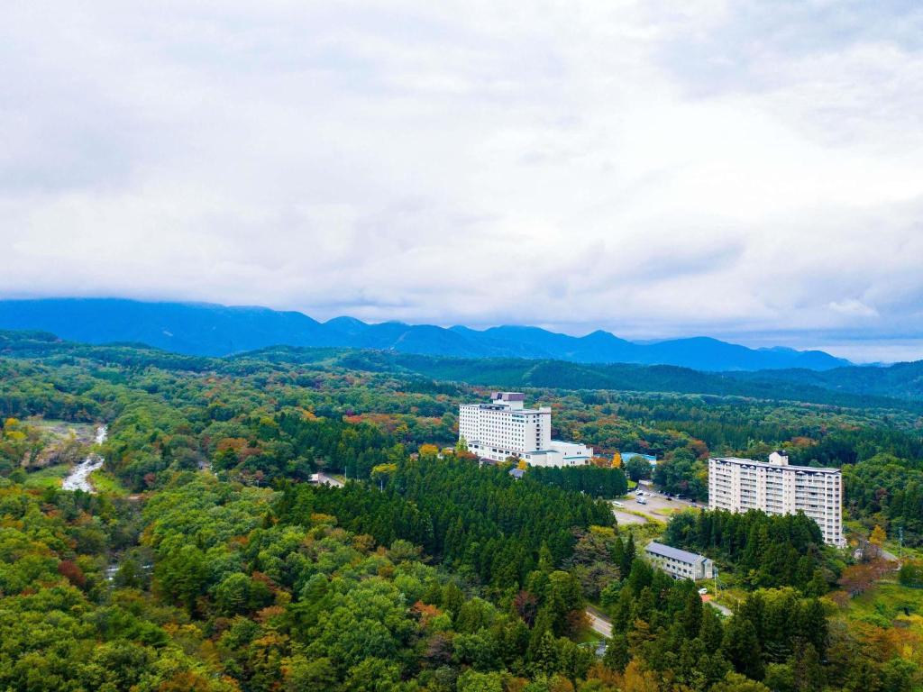 an aerial view of buildings in the forest at Mercure Miyagi Zao Resort & Spa in Zao