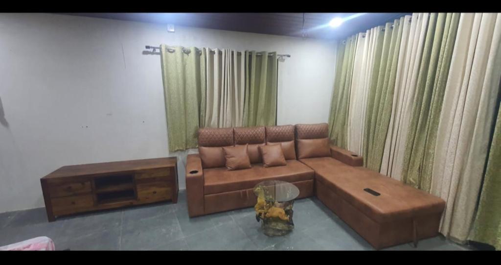 a living room with a couch and a coffee table at Unwind Farm Retreat in Hyderabad