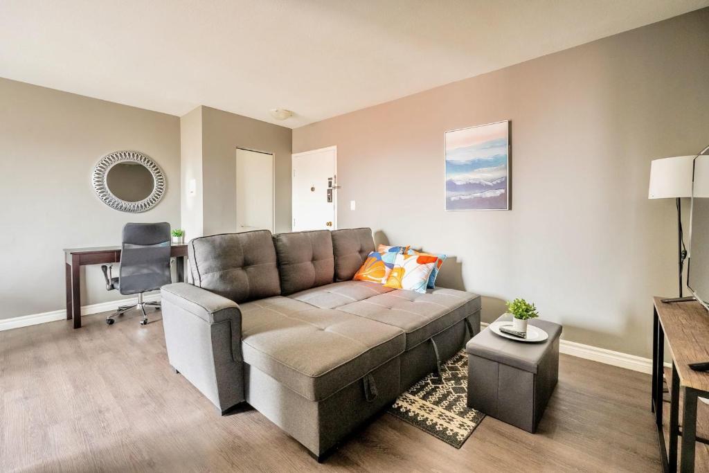 a living room with a couch and a table at Charming Newly Renovated Condo - Glenview West in Hamilton