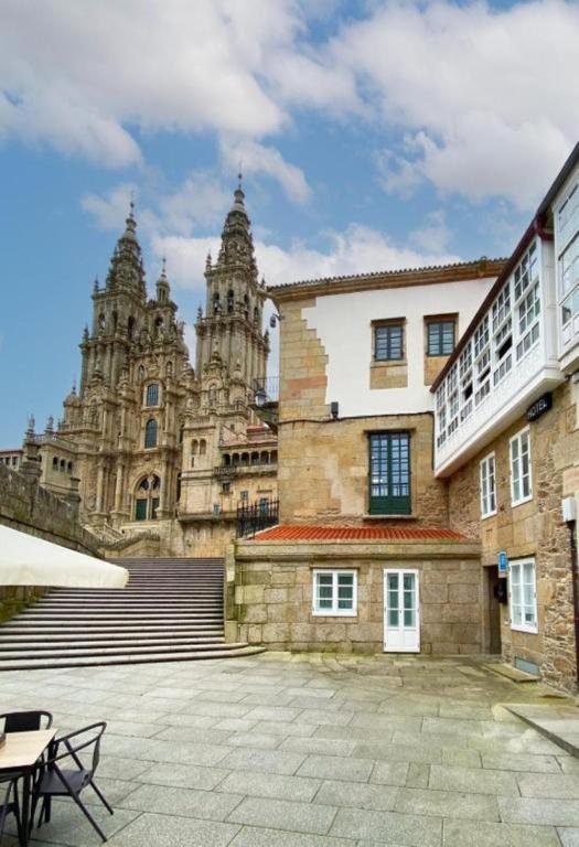 a building with stairs and turrets in the background at Hotel Plaza Obradoiro by Bossh! Hotels in Santiago de Compostela