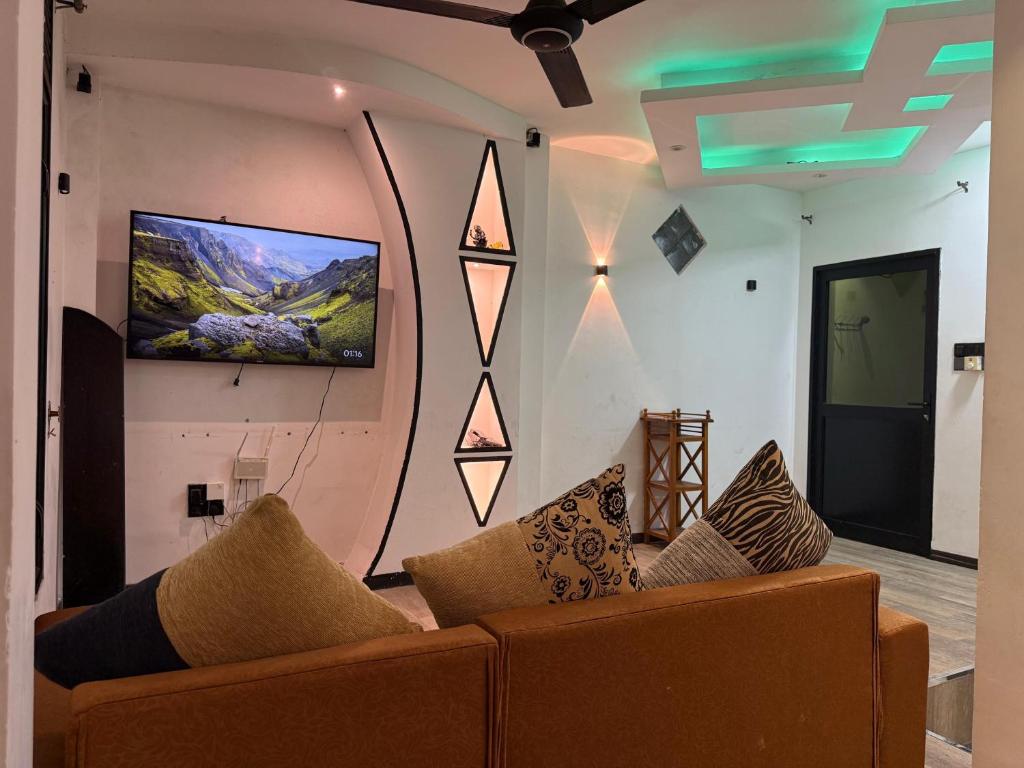a living room with a couch and a flat screen tv at Ayathma Heights in Weligama
