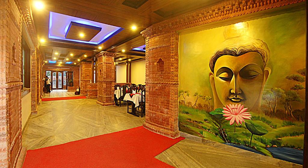 a room with a painting of a face on the wall at Hotel Buddha in Kathmandu
