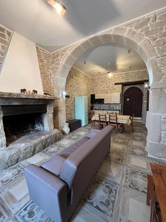 a living room with a couch and a fireplace at Casa vacanze La Fenice 2 in Pietranico