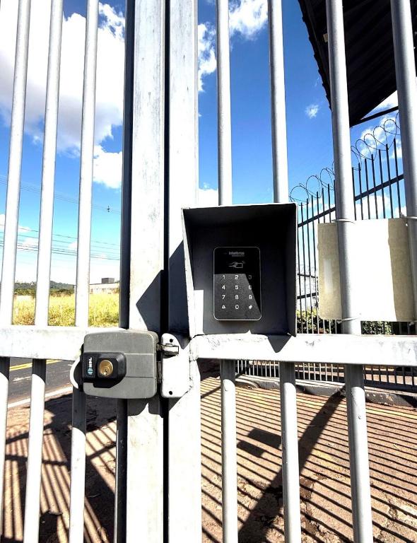 a pay phone sitting on the side of a fence at Cond Cristo Redentor in Trindade