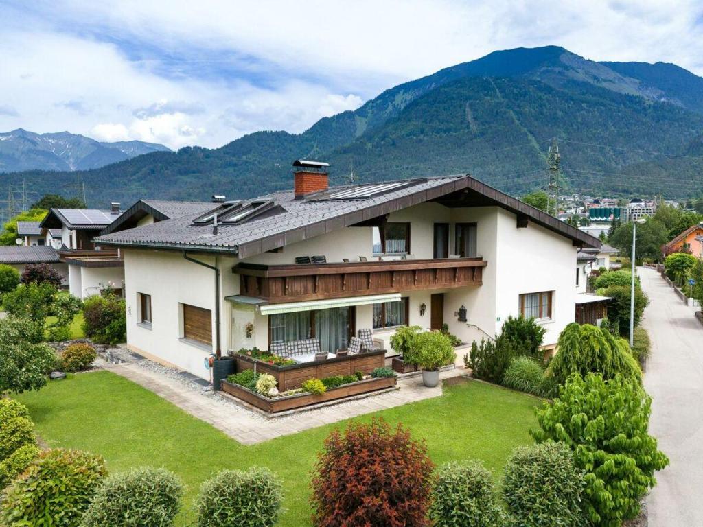 a house with a large yard in front of a mountain at Ferienwohnung Felder in Bürs