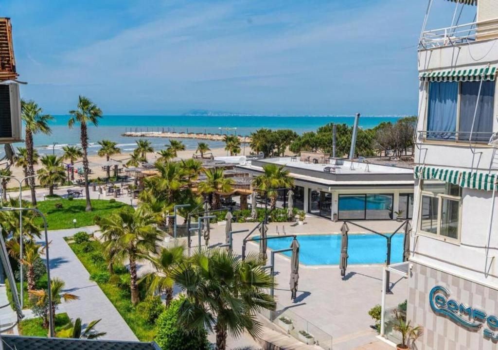 an aerial view of a resort with a pool and the ocean at Relax Seafront Apartment by PS in Golem