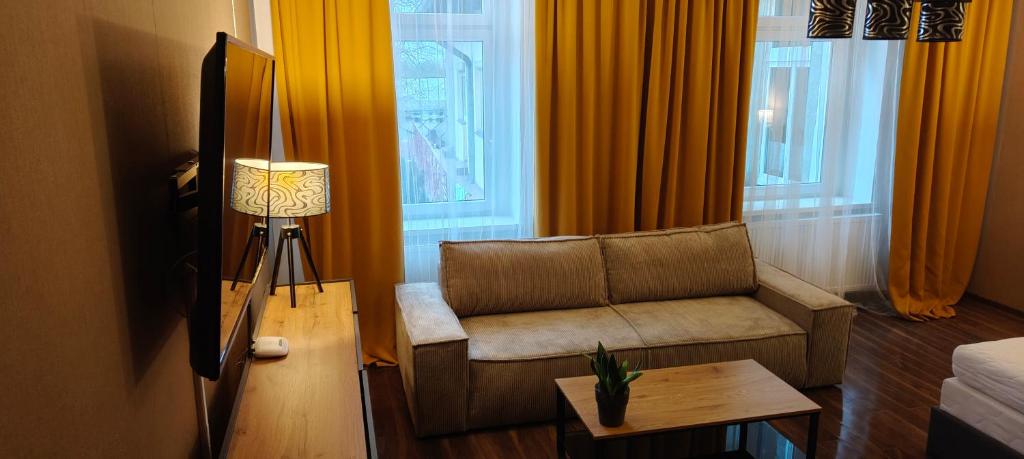 a living room with a couch and a table at Mieszkanie z Ogrodem in Kluczbork