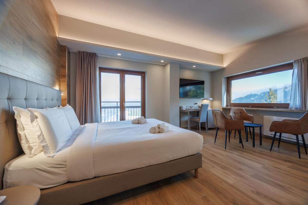 a hotel room with a large bed and a desk at Lift Hotel in Sauze dʼOulx