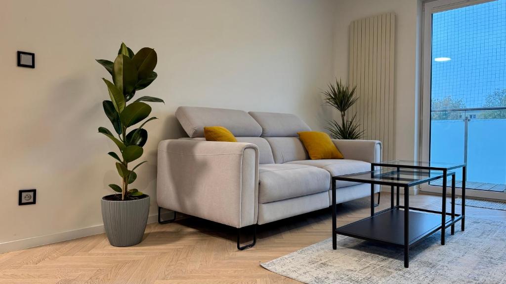 a living room with a couch and a glass table at Casa Nostra in Białystok