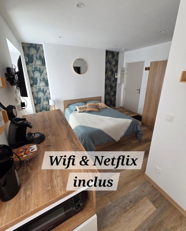 a small bedroom with a bed and a tv at Le Sebastopol- Studio cosy en centre ville de Brioude in Brioude