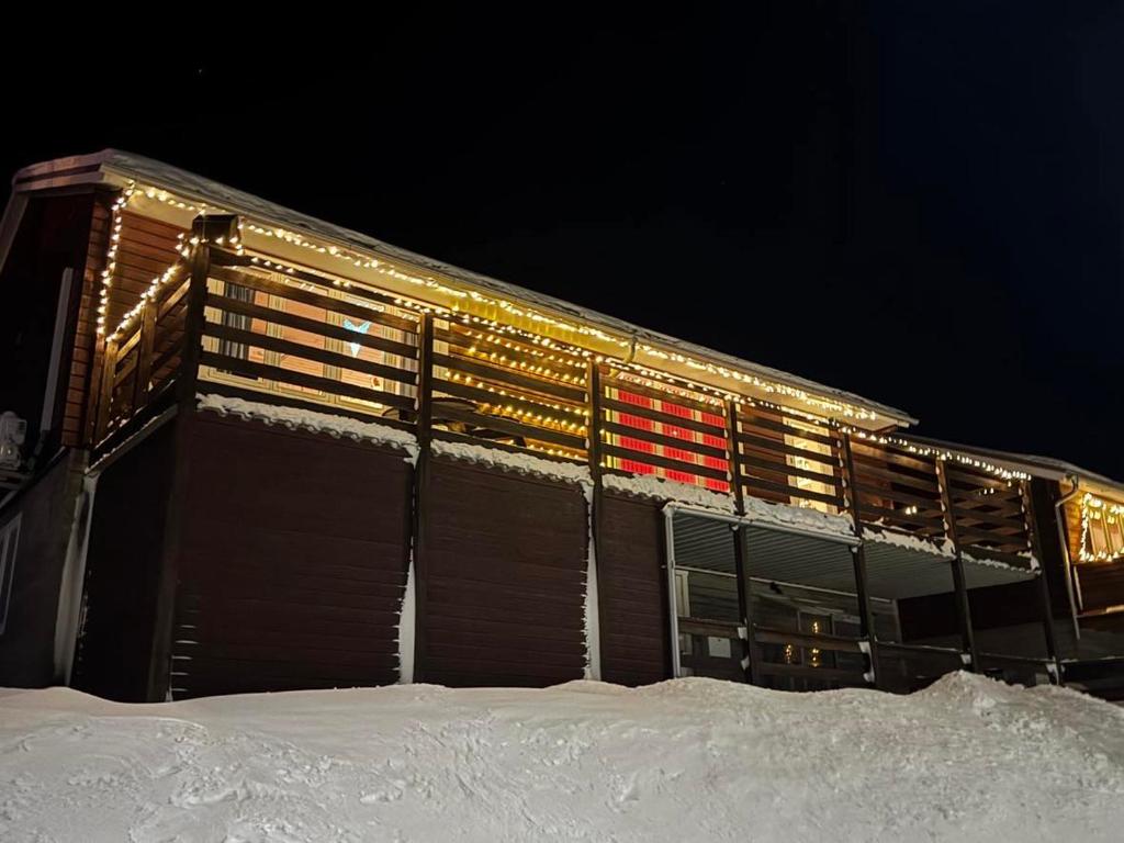 a building in the snow at night at Qaqortoq Spa Accommodation in Qaqortoq