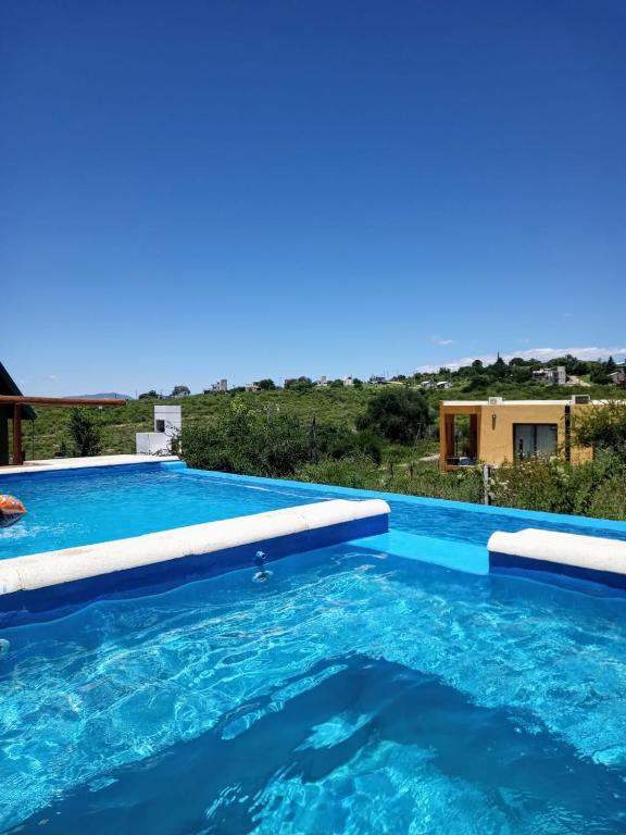 a swimming pool in a villa with a view at CABAÑAS L y L in Villa Santa Cruz del Lago