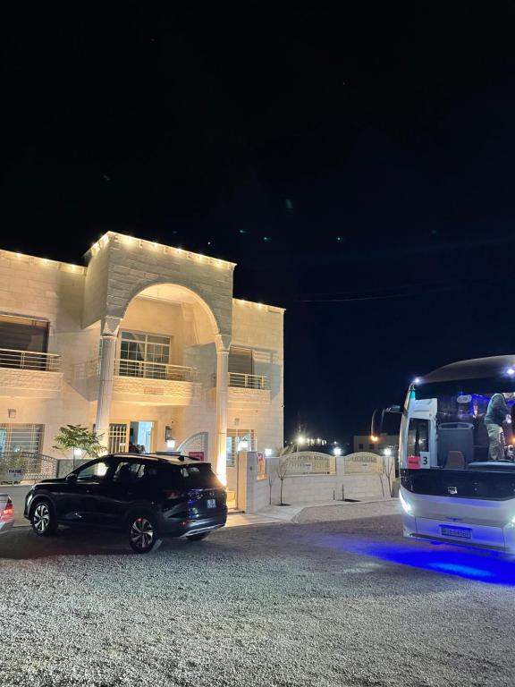 a car and a bus parked in front of a building at Airport Villa Amman in Amman