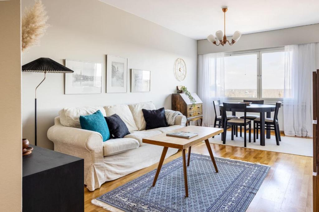 a living room with a couch and a table at Borg Isolinna, Spacious 2-Room Apt For 4, Free Parking in Pori