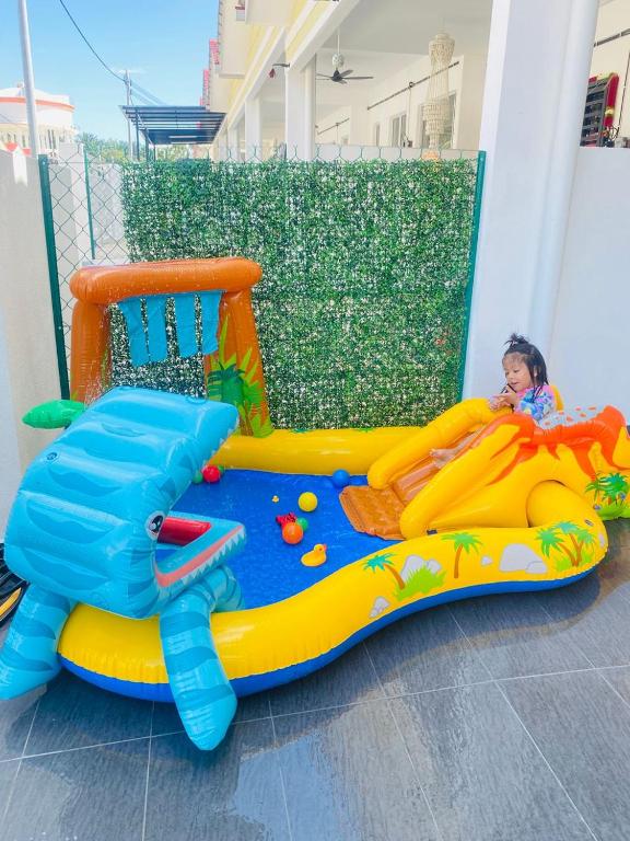 a little girl is playing in a inflatable at HomestayBondaFaiiha in Port Dickson