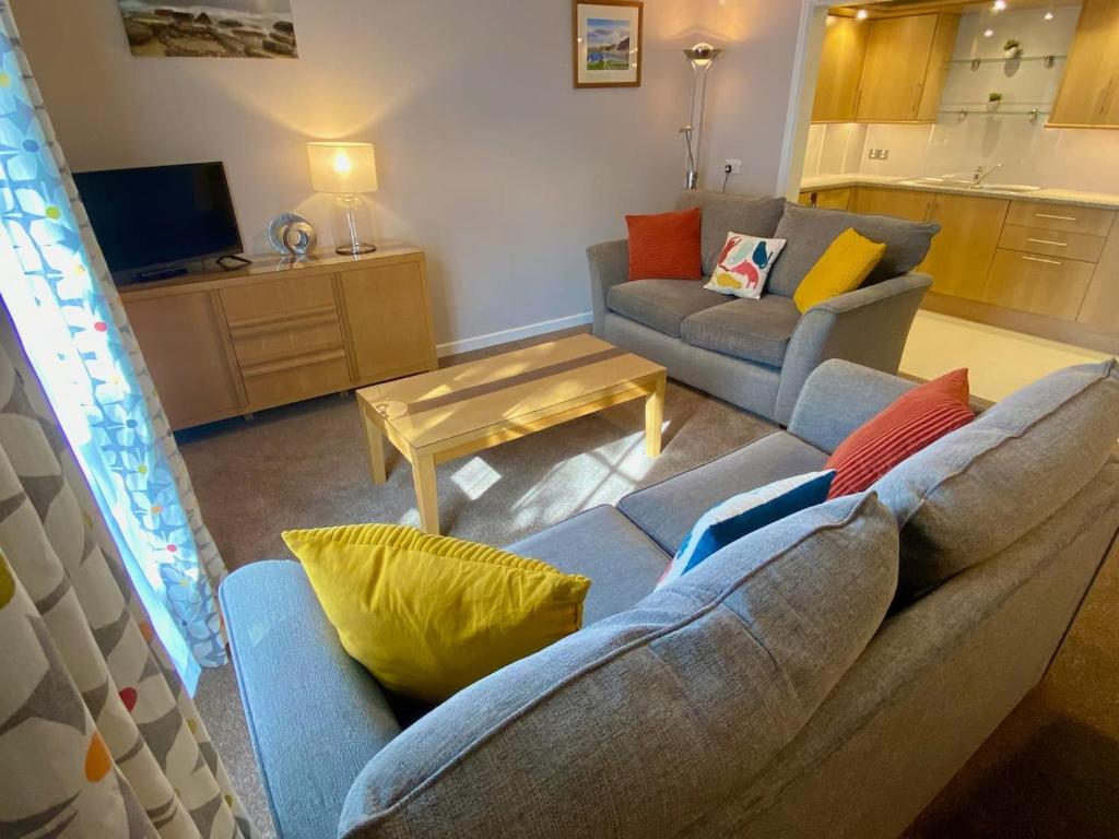 a living room with a couch and a table at Kirkwall town centre apartment 1 in Kirkwall