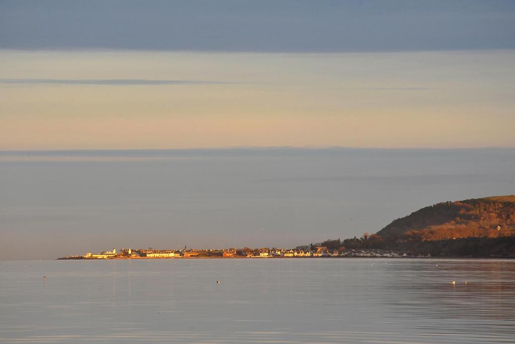 a large body of water with a town in the distance at The Royal Hotel Cromarty in Cromarty