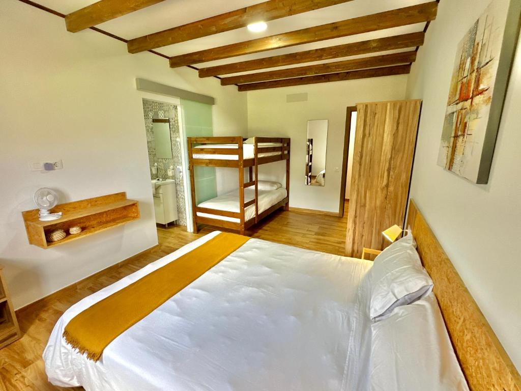 a bedroom with a large white bed in a room at Villa El Guanche -Boutique Apartments & rooms in Gáldar