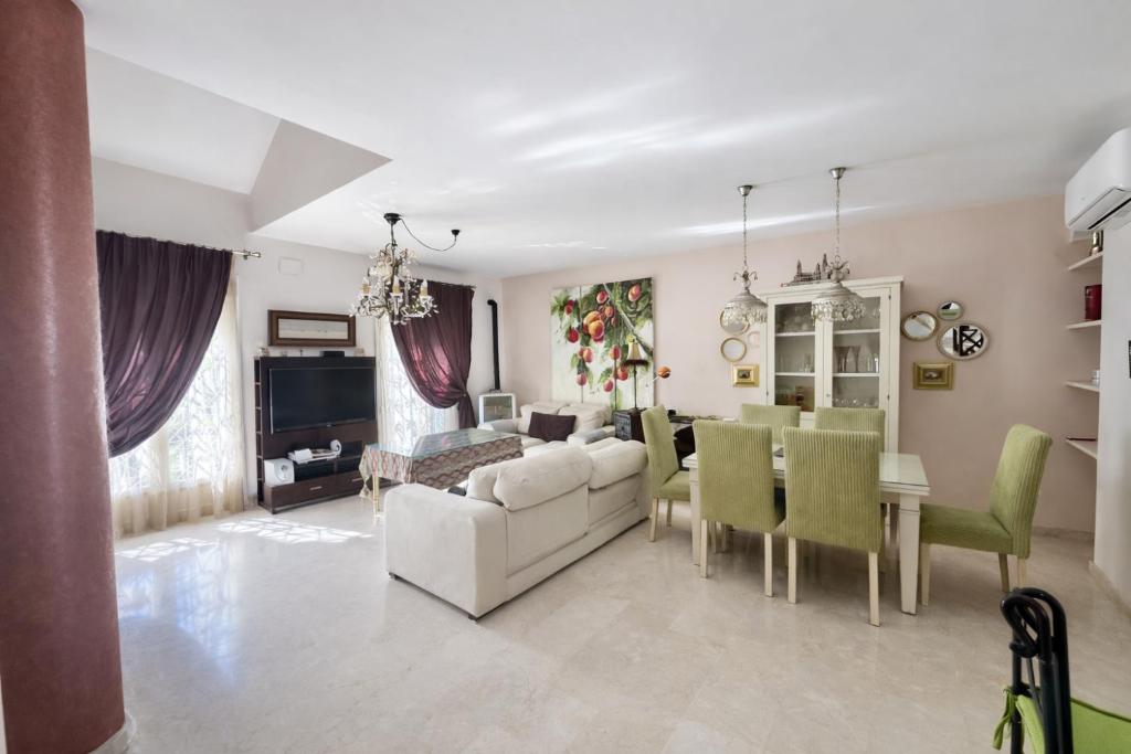 a living room with a couch and a table and chairs at Sonia Home in Córdoba