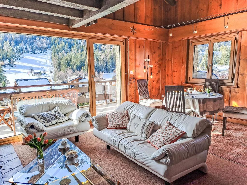 a living room with a couch and a table at Apartment Le Sporting by Interhome in Champex