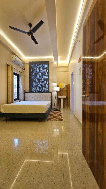 a bedroom with a bed and a ceiling fan at Buddha Premium Stays in Guwahati