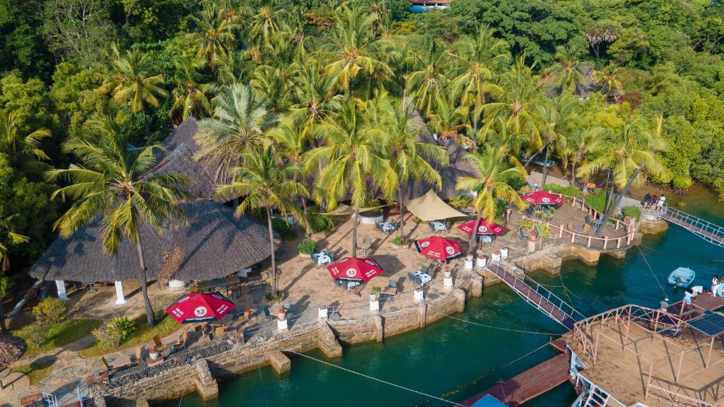 an aerial view of a resort with palm trees and water at Kasa First Apartment in Mtwapa