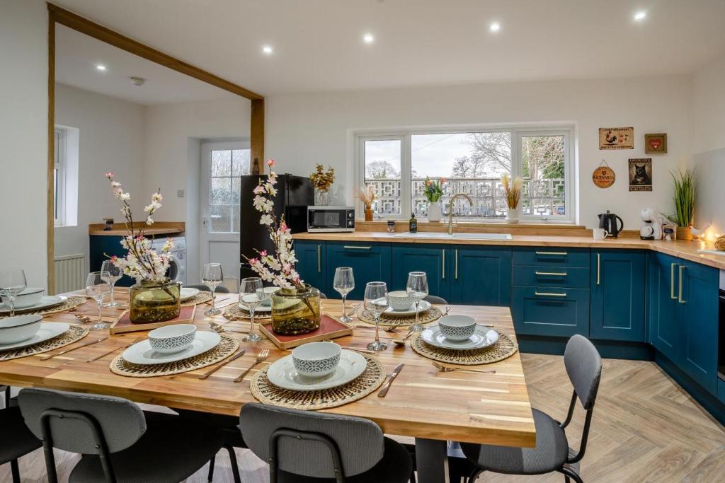 a kitchen with a wooden table and blue cabinets at 4 Bed in Brecon oc-h30823 in Brecon