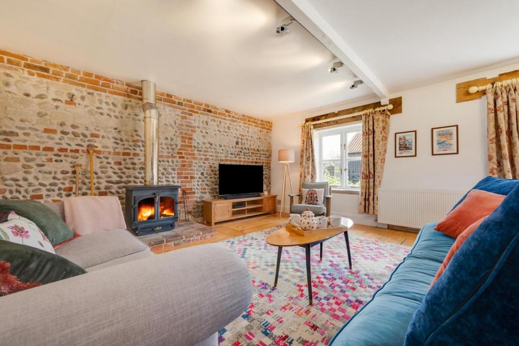 a living room with a couch and a fireplace at 3 Bed in Ridlington oc-2253 in Walcott