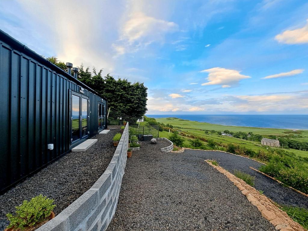 a train is parked next to a wall at Lothmore Lookout - Sunrise in Kilmote