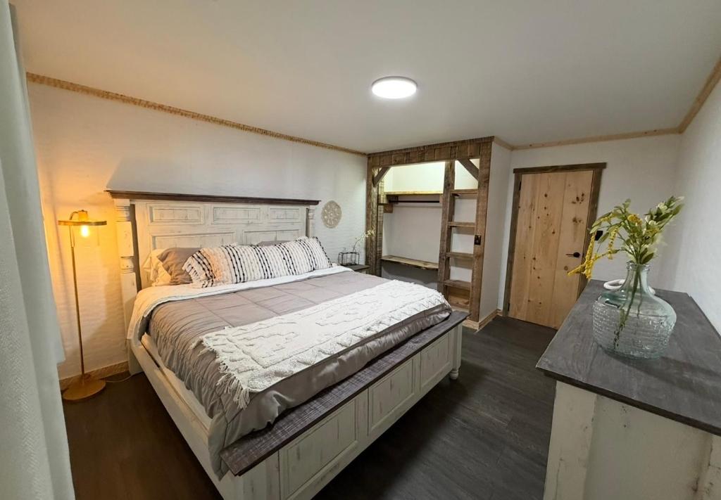 a bedroom with a bed and a vase of flowers at cozy cabin in Dalton